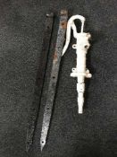 A cast metal water pump and a pair of cast iron gate clasps