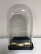 An antique glass dome on stand