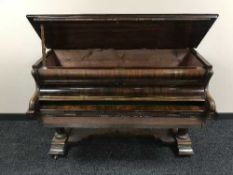 A rosewood baby grand piano converted into a writing desk