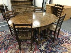 A Chapman's good quality reproduction oak gate leg table and five ladder back chairs