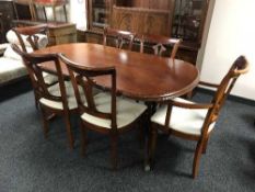 A twin pedestal extending dining table and six chairs