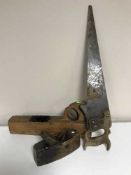 A box of vintage wood working planes and hand saws