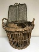A brass three way folding spark guard and two log baskets