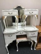 A white and gilt dressing table and a pair of bedside stands fitted a drawer