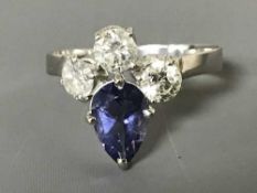 A pear-cut tanzanite and three stone diamond ring