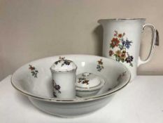 A four piece antique white floral china wash set