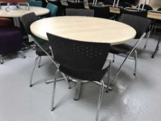 A circular pedestal office table and four Viasit stacking chairs
