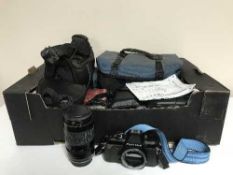 A box of camera bags containing video camera, digital camera, Pentax lens,