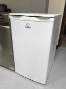 An Indesit under bench fridge