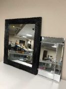 A black framed mirror together with a frameless mirror, unframed canvas, shoreline scene,