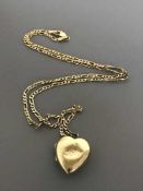 A locket on 9ct gold chain