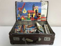 A leather case of boxed vintage Lego
