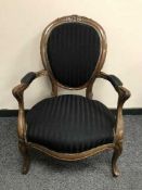 A continental mahogany salon armchair in stripped fabric