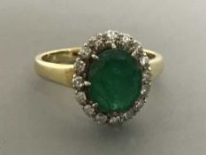 An 18ct gold emerald and diamond cluster ring, size O, 4.5g.