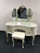 A cream and gilt dressing table with triple mirror and stool