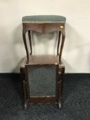 A mahogany storage piano stool,