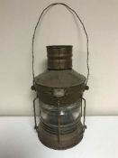A copper ship's lamp by The Humber Ship Wright Company and a brass ship's porthole