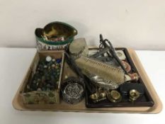 A tray of interesting collectables, three silver backed brushes, marbles, pistol lighter,
