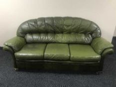 A green leather three seater settee
