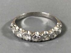 An 18ct white gold seven stone diamond half eternity ring, 2.7g, size M.
