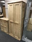 A pine double door pantry cupboard