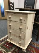 A light pine four drawer bedside chest
