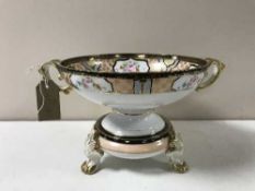 A Noritake gilded twin handled comport on stand