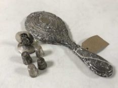 A silver backed hand mirror together with a small sterling silver paperweight bearing coat of arms,