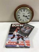 A box of assorted LP's, books relating to boxing, wall clock,