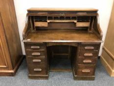 An Edwardian oak roll topped desk