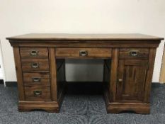 A pine twin pedestal desk with brass drop handles