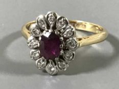 An 18ct gold ruby and diamond cluster ring, size N-O, 4.1g.
