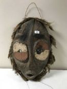 A carved hardwood tribal wall mask