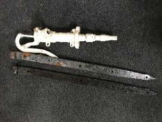A cast metal water pump and a pair of cast iron gate clasps