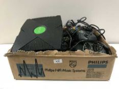 A box of two Xbox games consoles with lead and controllers