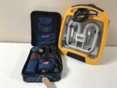 A Bosch Professional cordless screwdriver in case and a Defender site light