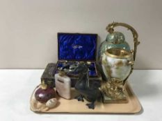 A tray containing boxed cutlery, an onyx and brass vase, brass embossed lidded urn,