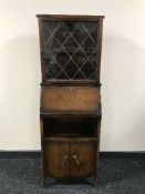 A narrow oak bureau bookcase