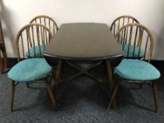 An Ercol elm drop leaf table and four chairs