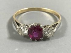 An 18ct gold three stone diamond and ruby ring,