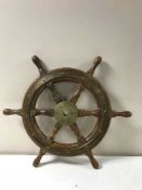 A wooden and brass ship's wheel