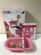 A quantity of doll's world toys including two boxed deluxe strollers, a boxed bath changing table,