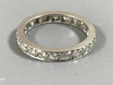 A platinum and diamond eternity ring