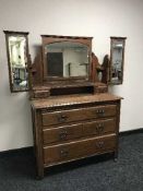 A late Victorian oak mirror door wardrobe and dressing chest with triple mirror
