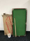 A child's table top snooker table with cues, balls and accessories,