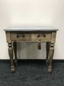 A two drawer side table with a metal top