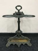 A cast iron stick stand with lift out tray