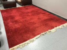 A large red embossed fringed carpet
