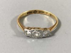 An 18ct gold three stone diamond ring