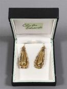 A pair of antique gold earrings